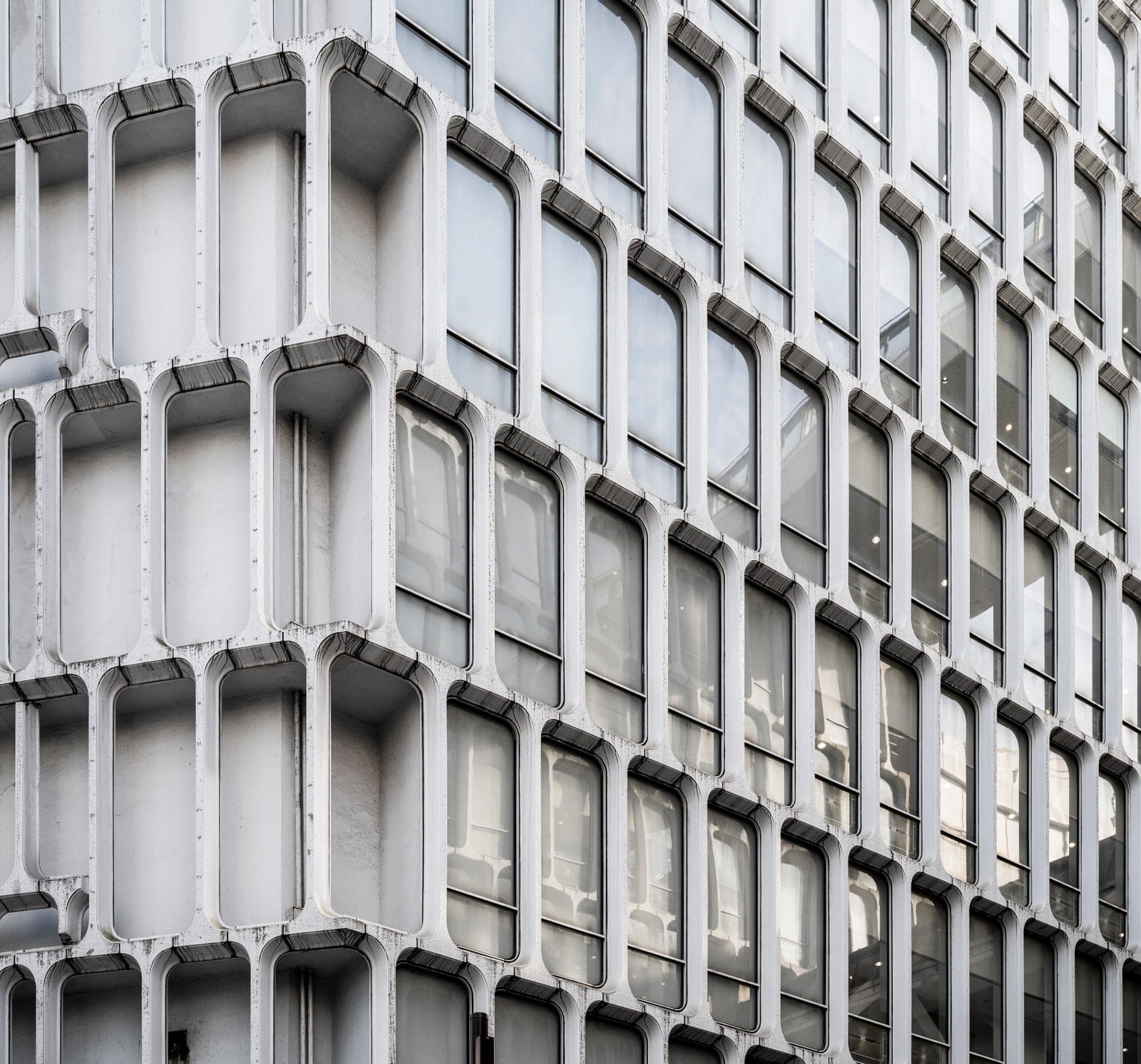 Repeating concrete window bays on a brutalist facade